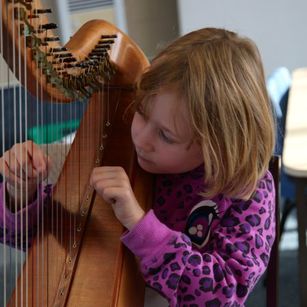 Girl learning to play the harp