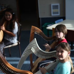Children learning to play the harp