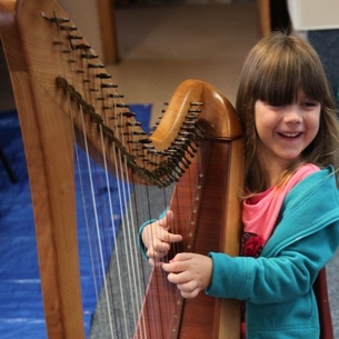 Little girl playing the harp